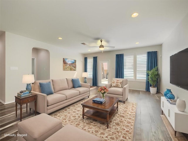 1432 Uhland Dr, Leander, TX 78641 - living area with arched walkways, wood finished floors, ceiling fan, recessed lighting, and baseboards