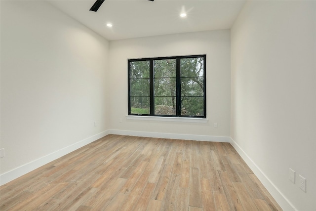 spare room featuring ceiling fan and light hardwood / wood-style floors