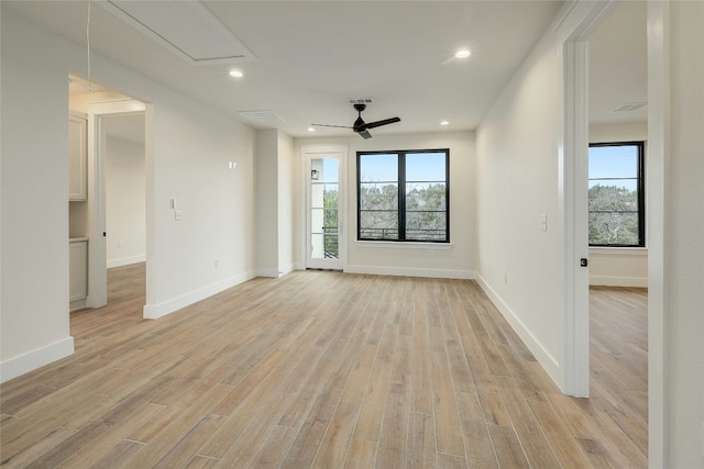 spare room with ceiling fan, light hardwood / wood-style flooring, and a healthy amount of sunlight