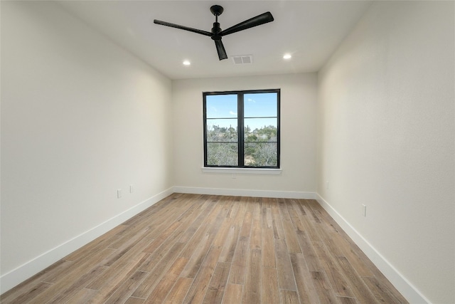 empty room featuring ceiling fan and light hardwood / wood-style floors