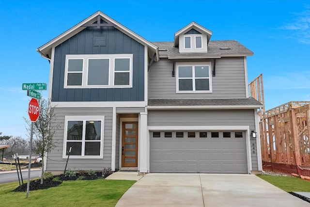 view of front of house featuring a garage and a front lawn