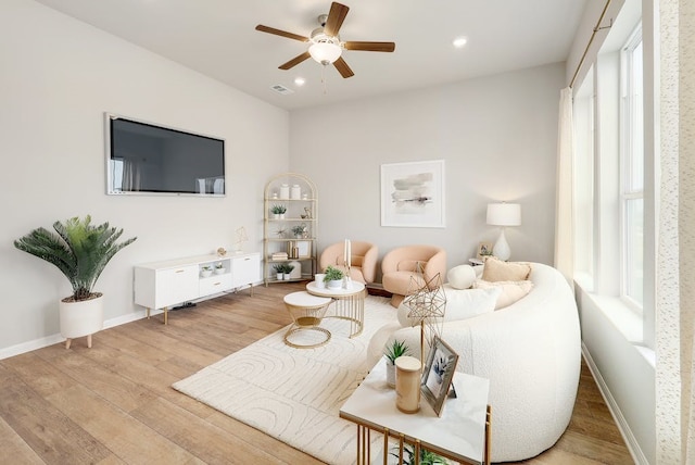 living room featuring light wood-type flooring and ceiling fan