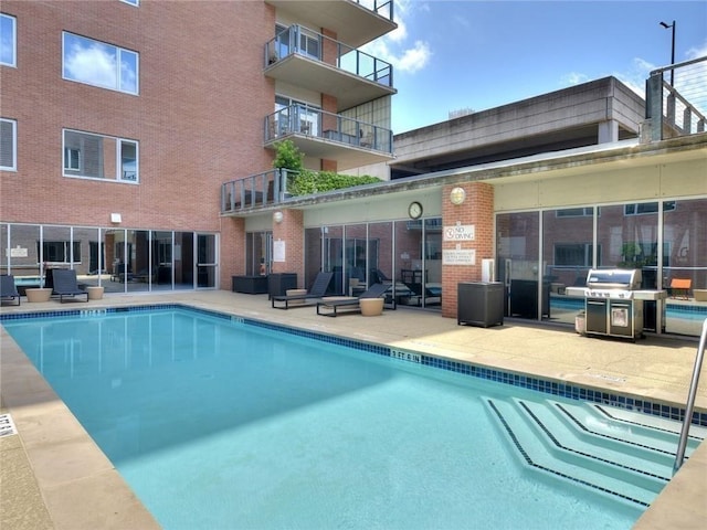 view of pool featuring area for grilling