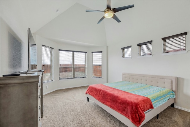 carpeted bedroom with baseboards, high vaulted ceiling, and a ceiling fan