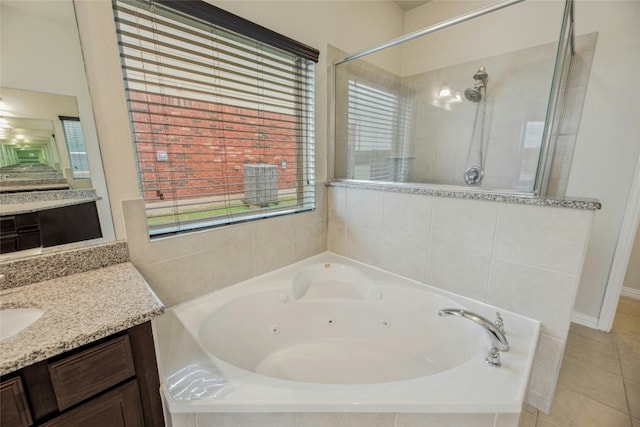 full bathroom featuring tile patterned floors, a stall shower, two vanities, and a jetted tub