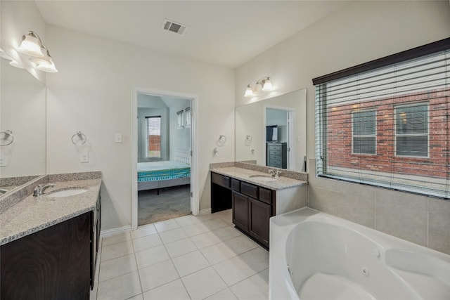 full bathroom featuring two vanities, visible vents, ensuite bathroom, a sink, and tile patterned flooring