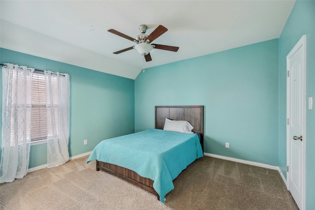 carpeted bedroom featuring ceiling fan, baseboards, and vaulted ceiling