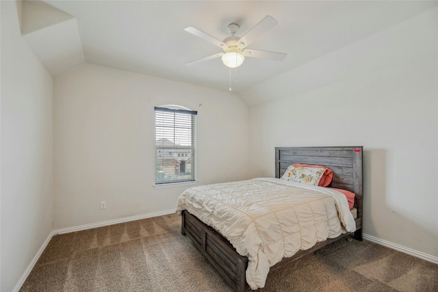 carpeted bedroom featuring baseboards, vaulted ceiling, and a ceiling fan