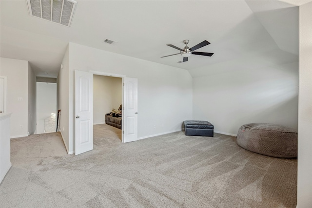 interior space with light carpet, ceiling fan, and visible vents