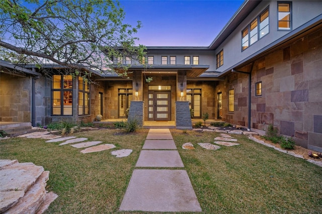 702 Crystal Mountain Dr, Austin, TX 78733 - view of exterior entry featuring a yard and stone siding