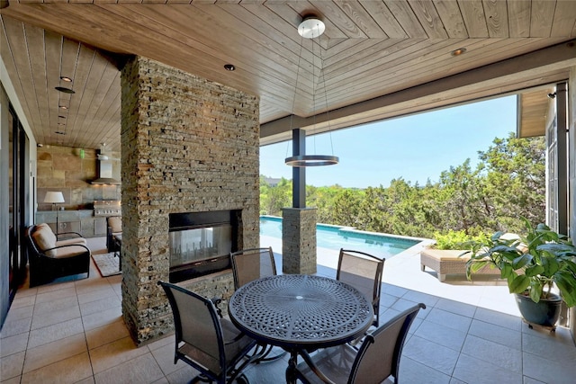 702 Crystal Mountain Dr, Austin, TX 78733 - view of patio with outdoor dining area, an outdoor pool, and an outdoor stone fireplace