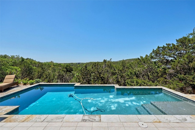 702 Crystal Mountain Dr, Austin, TX 78733 - swimming pool featuring a wooded view