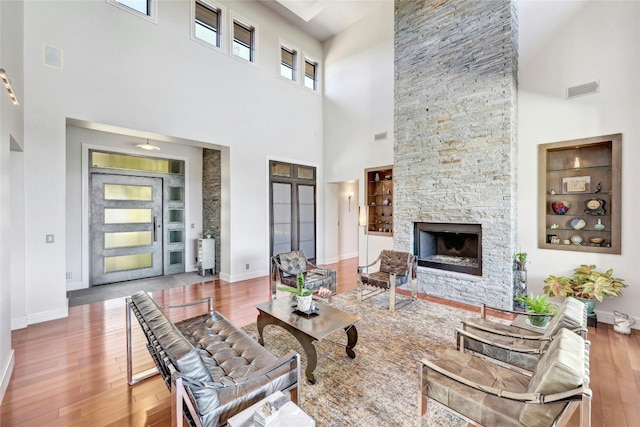 702 Crystal Mountain Dr, Austin, TX 78733 - living area featuring a towering ceiling, wood finished floors, and a fireplace