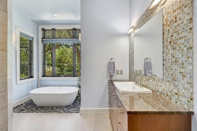 702 Crystal Mountain Dr, Austin, TX 78733 - full bathroom featuring vanity, a freestanding tub, tile patterned floors, and tasteful backsplash