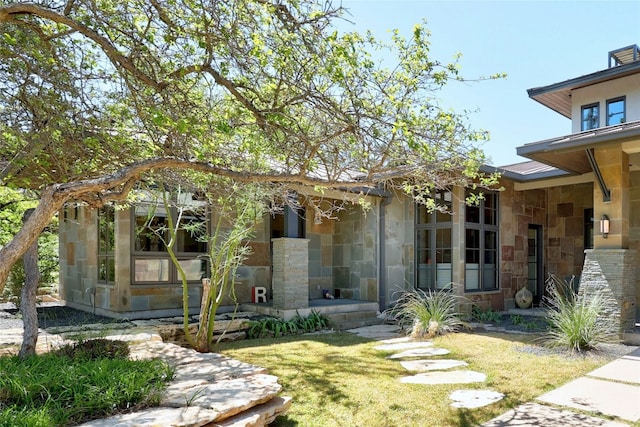 702 Crystal Mountain Dr, Austin, TX 78733 - view of front of house featuring stone siding and a front lawn