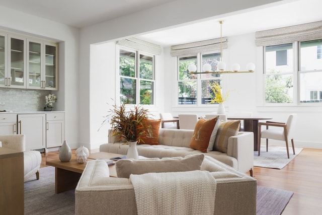 sunroom featuring a notable chandelier