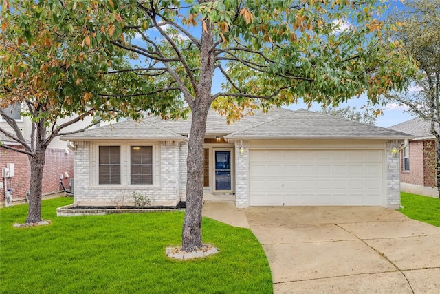 ranch-style house featuring a garage and a front lawn