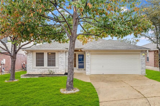 3580 Rock Shelf Ln, Round Rock, TX 78681 - view of front of home with a front yard, an attached garage, and concrete driveway