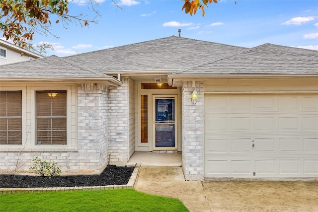 3580 Rock Shelf Ln, Round Rock, TX 78681 - doorway to property featuring a shingled roof, a garage, and brick siding