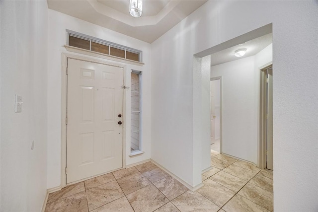 entrance foyer with a tray ceiling