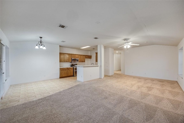3580 Rock Shelf Ln, Round Rock, TX 78681 - unfurnished living room with vaulted ceiling, a ceiling fan, light colored carpet, and a chandelier