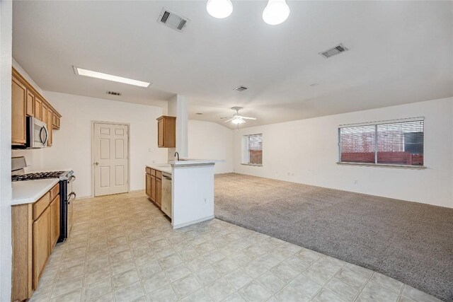 3580 Rock Shelf Ln, Round Rock, TX 78681 - kitchen featuring appliances with stainless steel finishes, open floor plan, ceiling fan, and brown cabinets