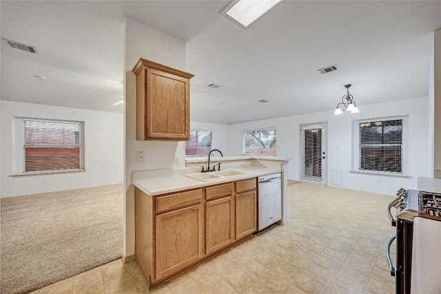 kitchen with appliances with stainless steel finishes, sink, kitchen peninsula, and light colored carpet