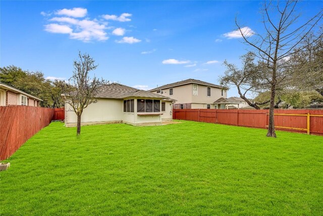 3580 Rock Shelf Ln, Round Rock, TX 78681 - back of house featuring a fenced backyard, a sunroom, and stucco siding