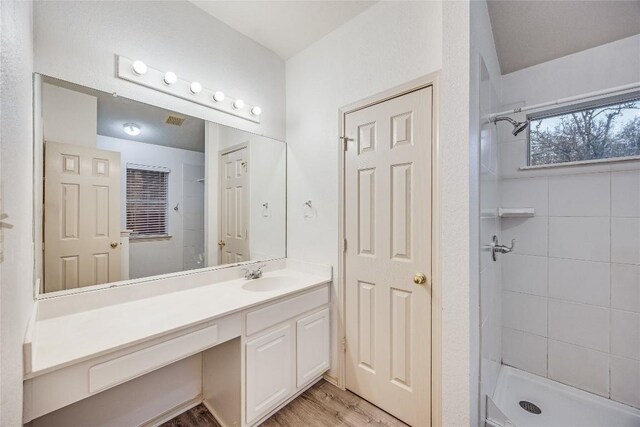 3580 Rock Shelf Ln, Round Rock, TX 78681 - full bath featuring vanity, tiled shower, and wood finished floors