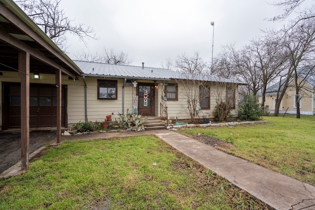 single story home featuring a front lawn and a garage