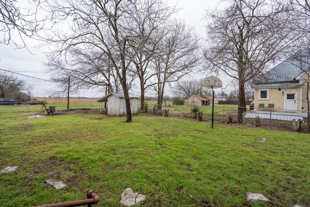 view of yard with a rural view and a shed