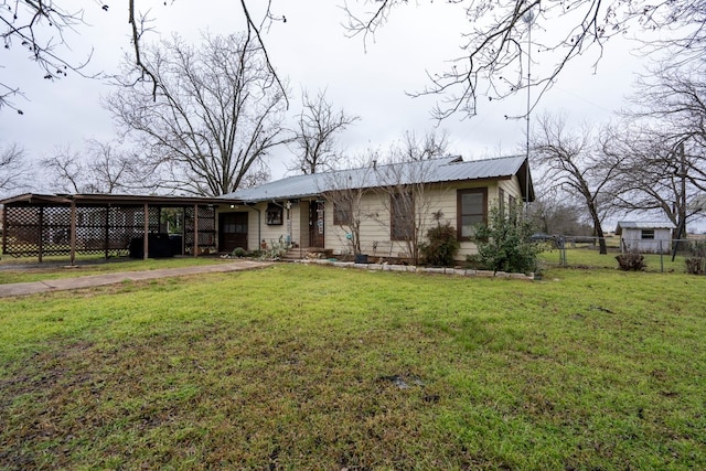 single story home featuring a front lawn and a carport