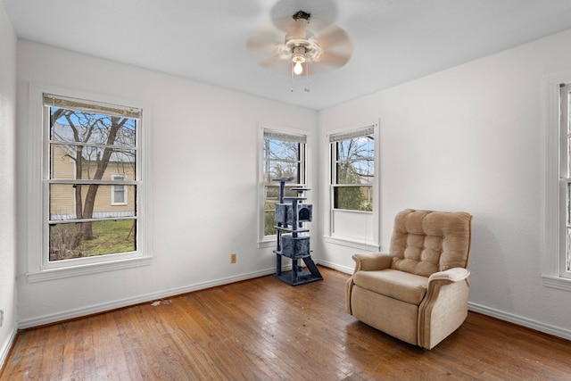 sitting room with ceiling fan, hardwood / wood-style flooring, and plenty of natural light