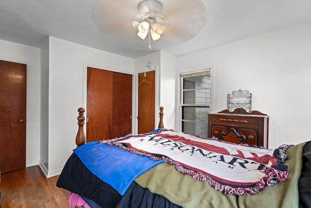 bedroom with dark hardwood / wood-style floors and ceiling fan