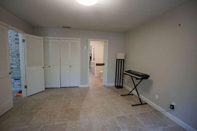 bedroom featuring ensuite bath and a closet