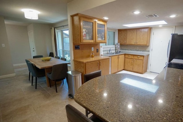 kitchen featuring sink and stainless steel fridge