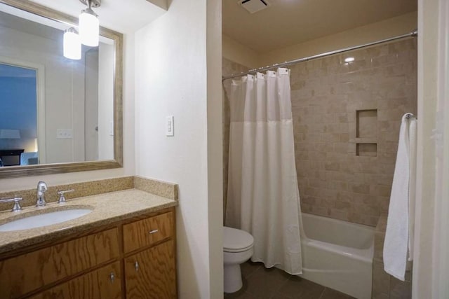 full bathroom featuring tile patterned floors, vanity, toilet, and shower / bath combination with curtain