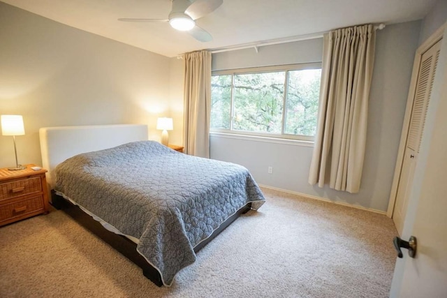 bedroom with light carpet, a closet, and ceiling fan