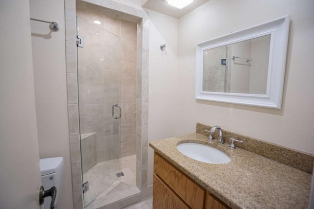 bathroom with vanity, toilet, and walk in shower