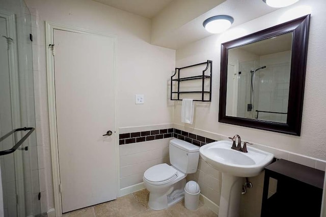 3610 Branigan Ln, Austin, TX 78759 - bathroom with a shower stall, a wainscoted wall, and tile patterned floors
