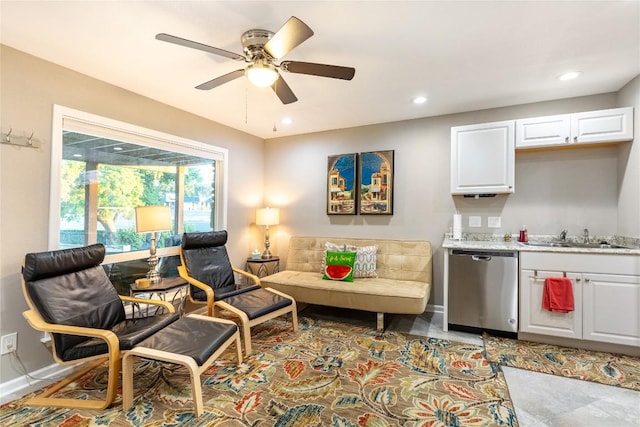 living room featuring ceiling fan and sink