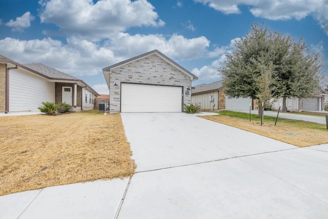 ranch-style house with driveway, a garage, stone siding, cooling unit, and a front yard