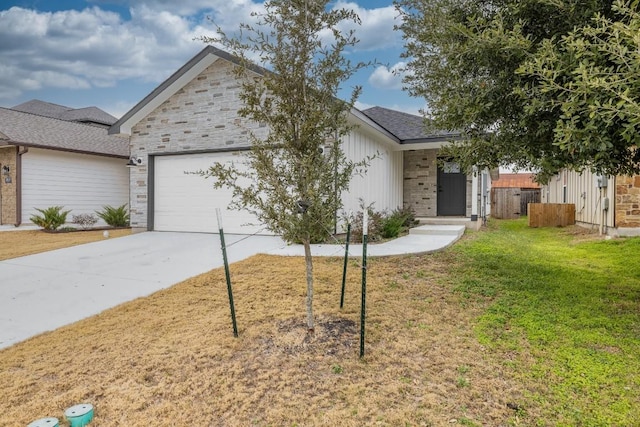 ranch-style home featuring a garage, driveway, stone siding, fence, and a front yard