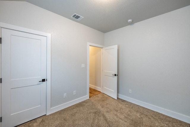 unfurnished bedroom with light carpet, baseboards, and visible vents