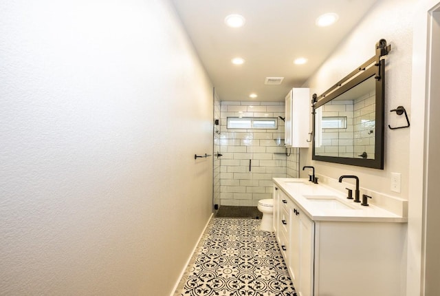 full bathroom with visible vents, toilet, a sink, a shower stall, and tile patterned flooring