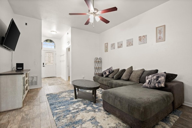 living room featuring ceiling fan and wood-type flooring