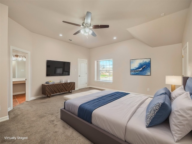 carpeted bedroom featuring lofted ceiling, ceiling fan, and ensuite bath