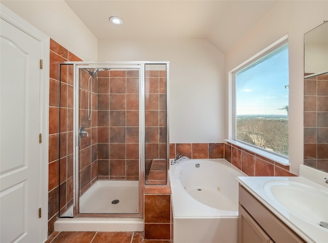 bathroom with tile patterned floors, separate shower and tub, vaulted ceiling, and vanity