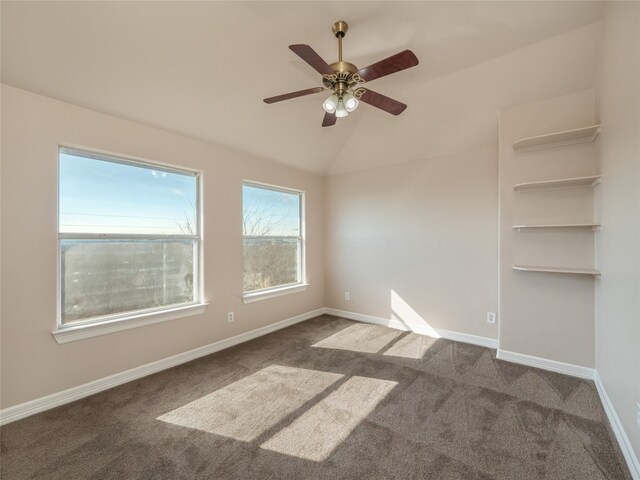 empty room with vaulted ceiling, carpet flooring, and ceiling fan