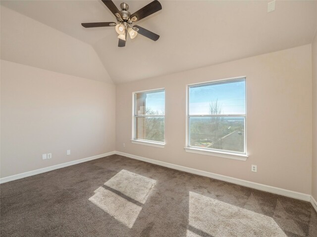 empty room with vaulted ceiling, carpet flooring, and ceiling fan